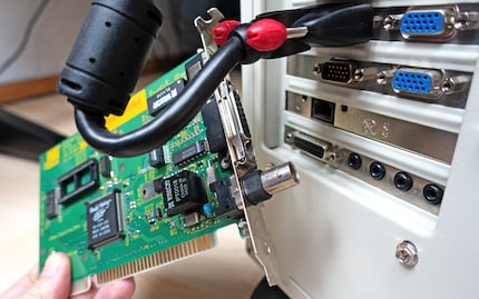 Allied Telesyn’s blue screen network card next to the new, working RJ45 port of an Intel Pro/100 S.